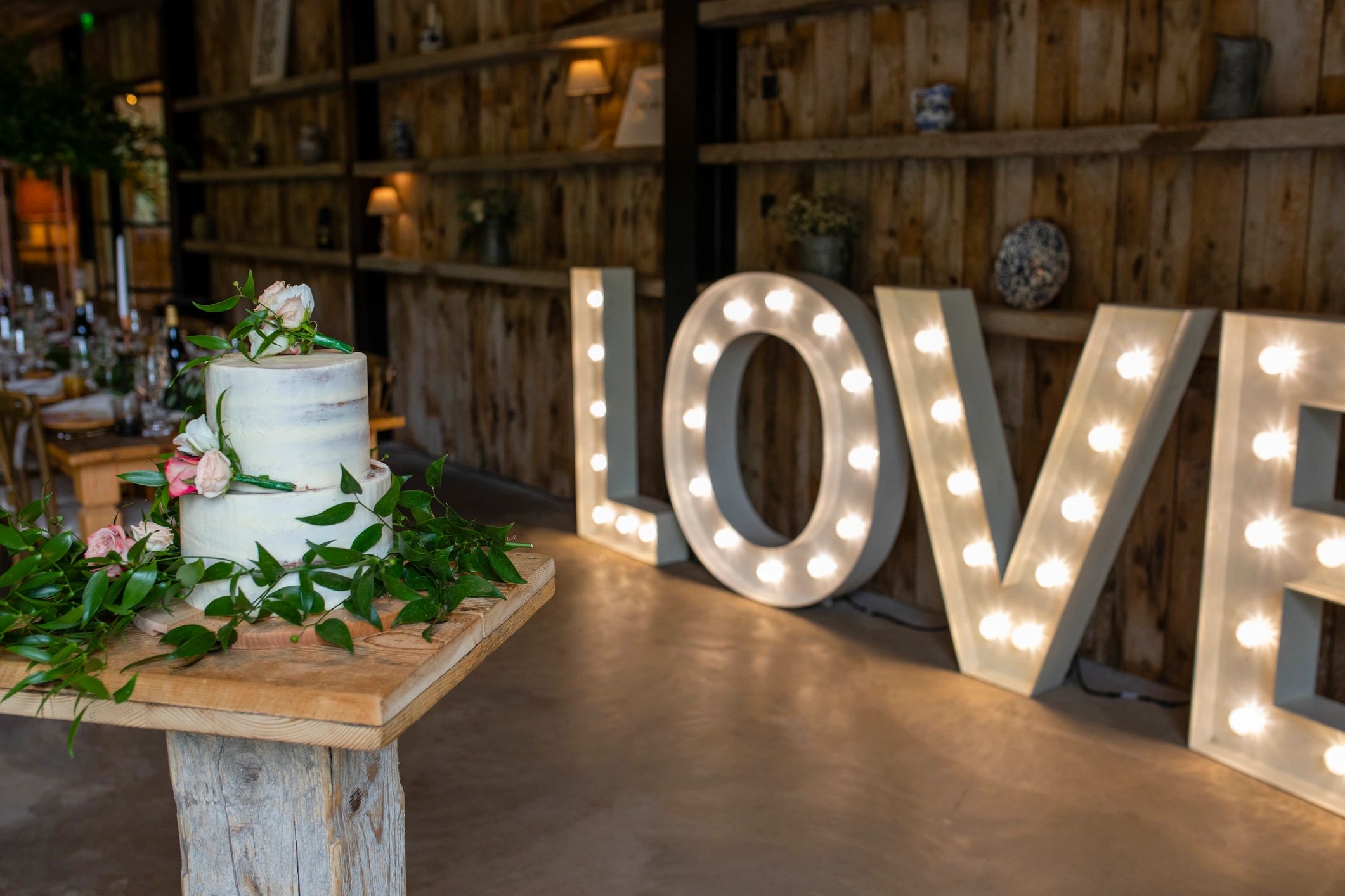 Decorated cake and illuminated love letters at a reception