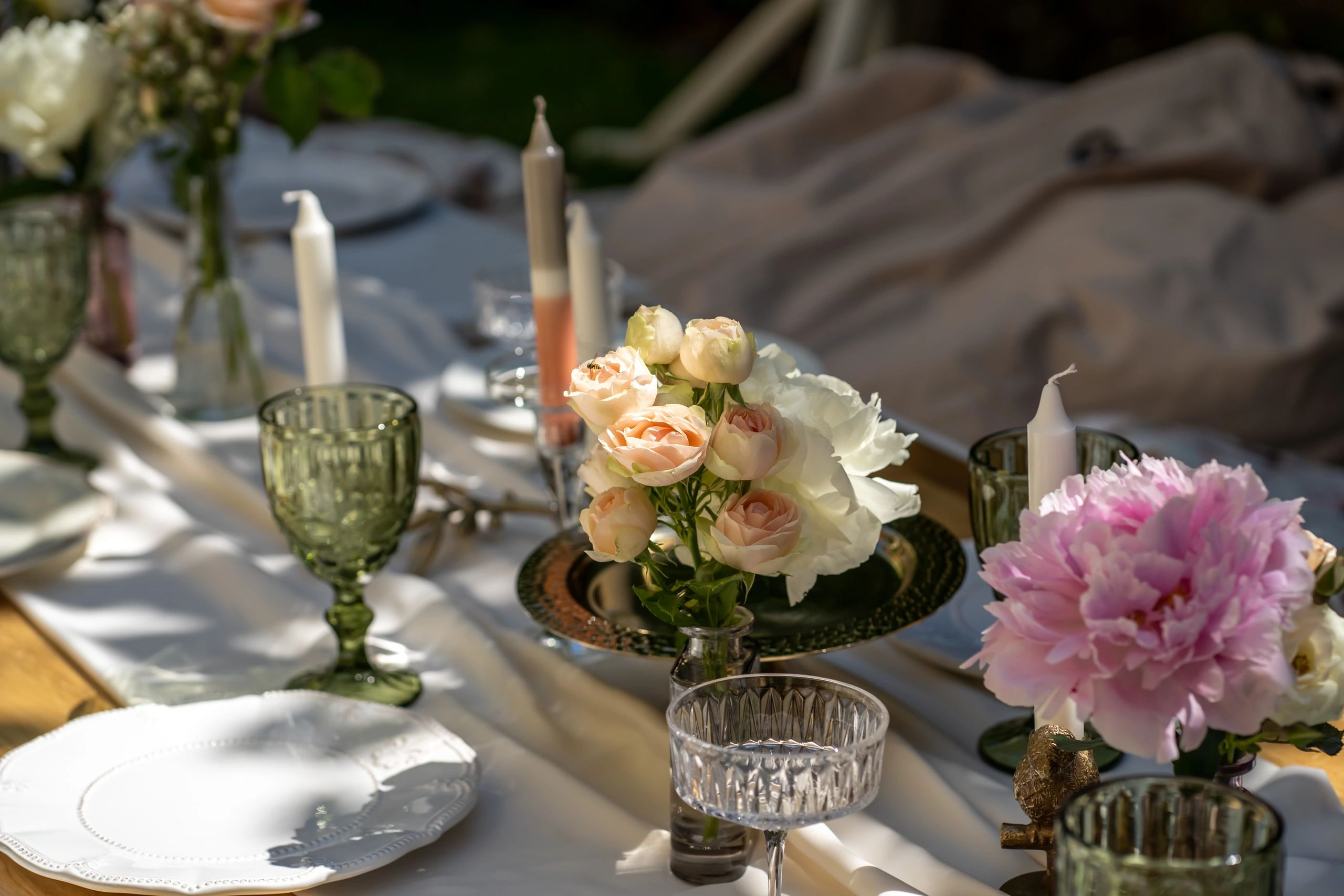 Styled party table setting with flowers and glassware
