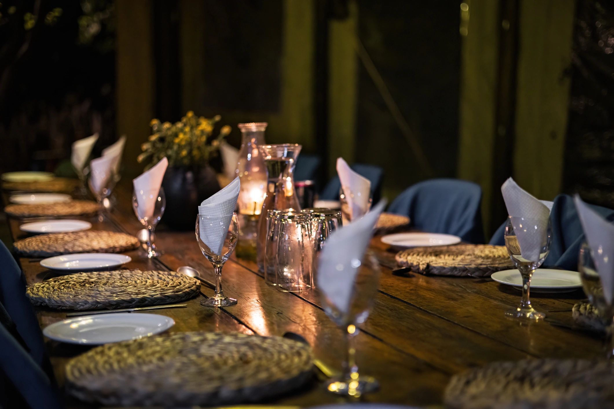 Candlelit dinner table set for guests